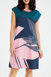 Model Andrea wearing size S of the Bobby Dress in colour Pink (Blue), from the front, cropped image