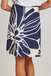 Model Madeline wearing size S of the Avril Cotton Skirt in colour Indigo (Blue), from the back