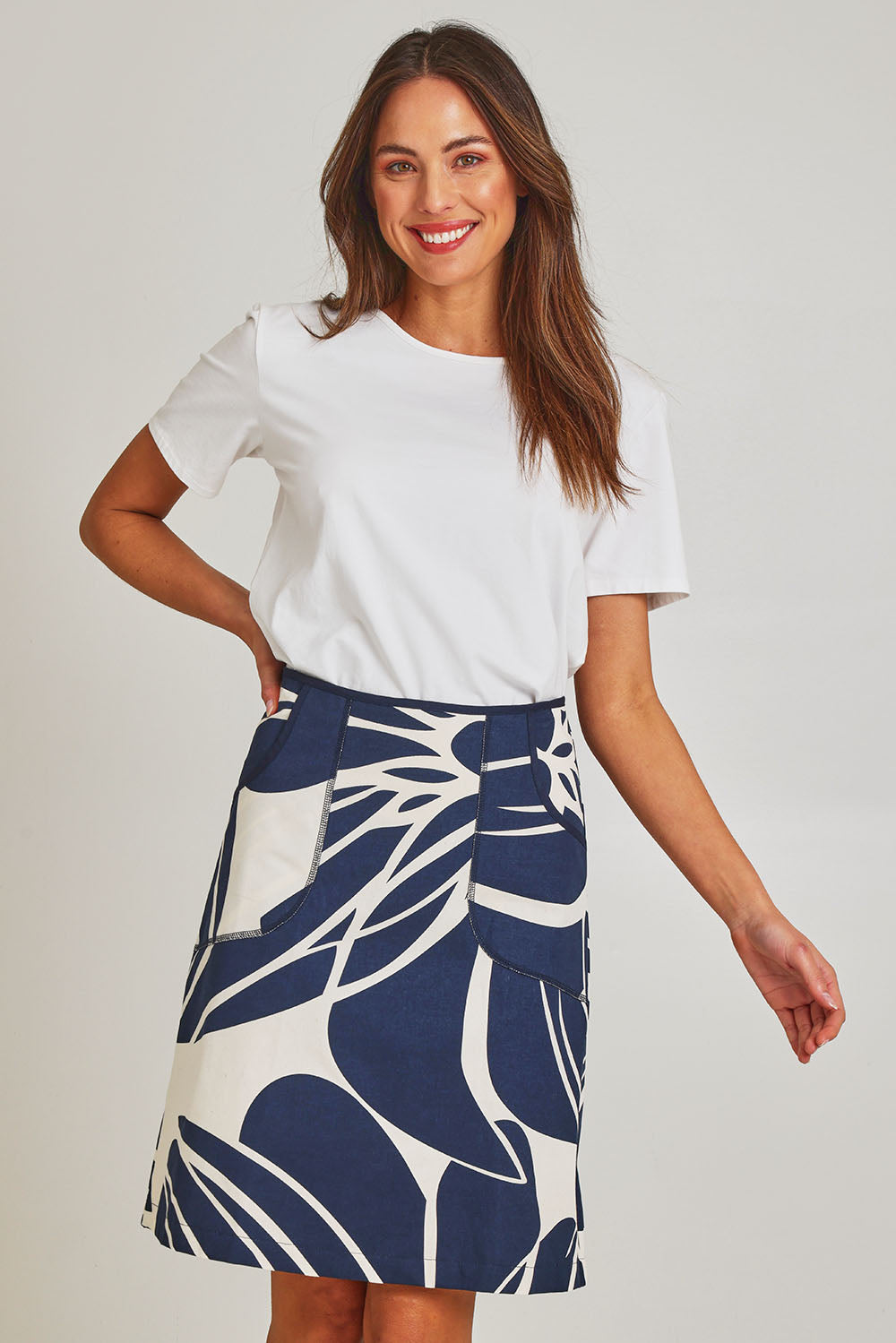 Model Madeline wearing size S of the Avril Cotton Skirt in colour Indigo (Blue), from the front, cropped image