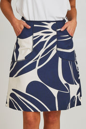 Model Madeline wearing size S of the Avril Cotton Skirt in colour Indigo (Blue), from the front, cropped image