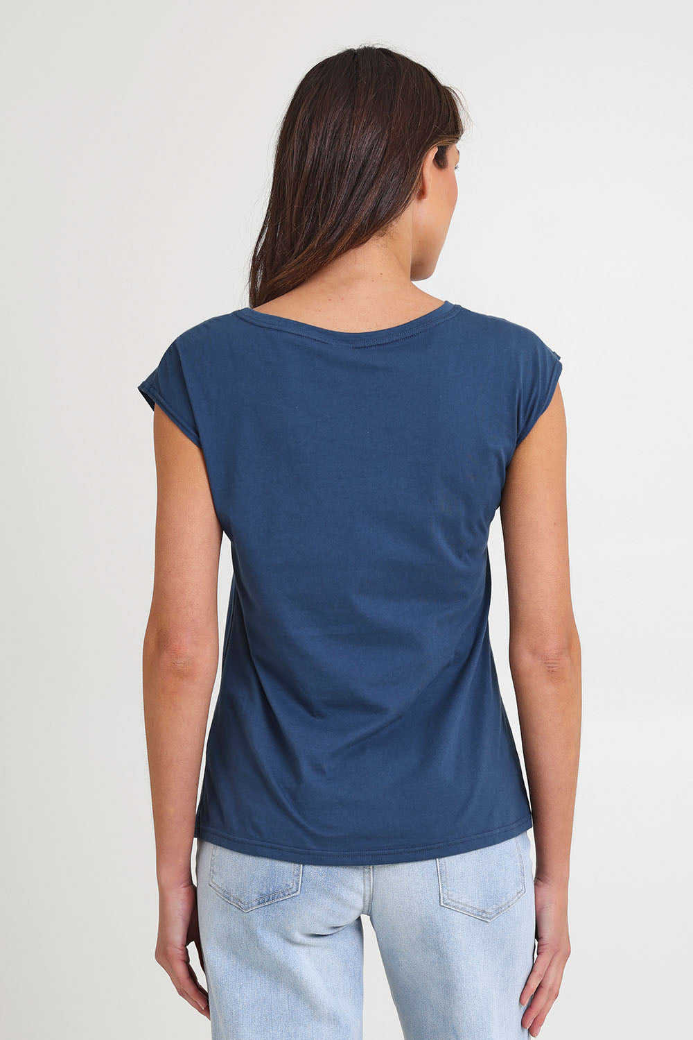 Model Madeline wearing size S of the Bobby Cotton Top in colour Articblue (Blue), from the back