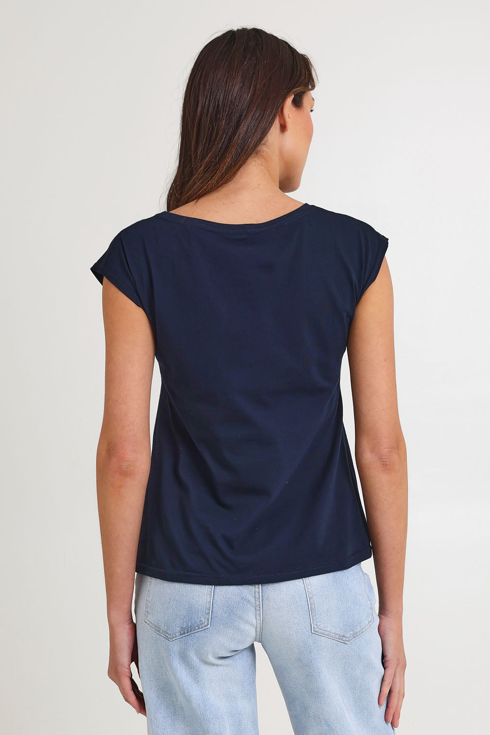 Model Madeline wearing size S of the Bobby Cotton Top in colour Navylark (Blue), from the back