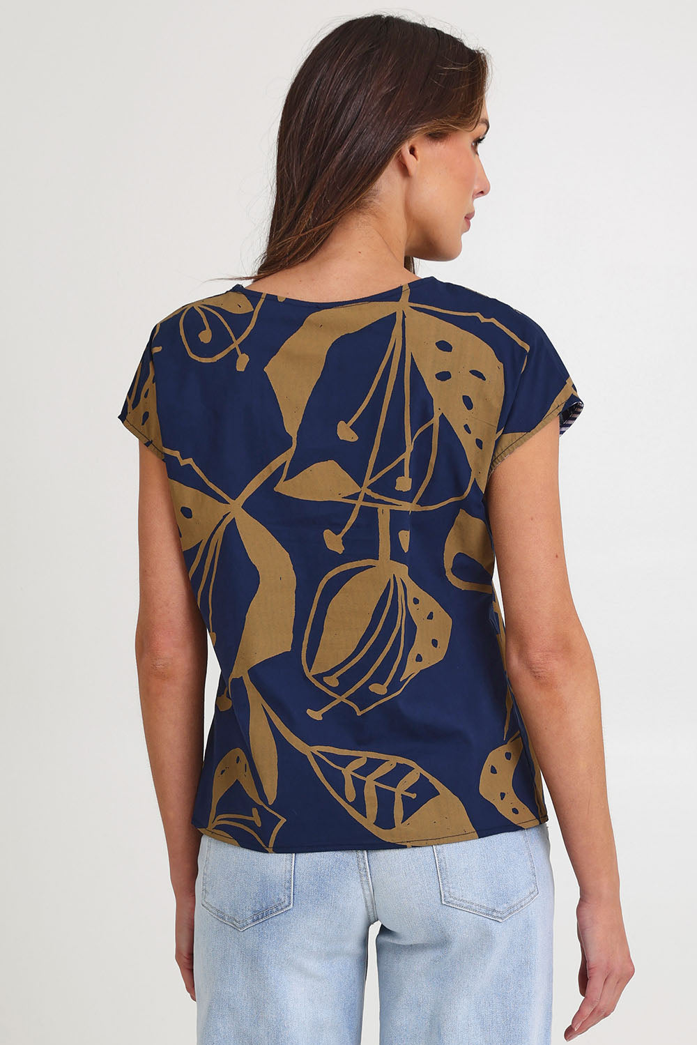 Model Madeline wearing size S of the Tilly Cotton Top in colour Navy (Blue), from the back