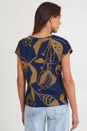 Model Madeline wearing size S of the Tilly Cotton Top in colour Navy (Blue), from the back