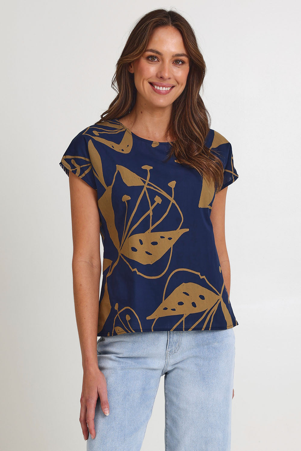 Model Madeline wearing size S of the Tilly Cotton Top in colour Navy (Blue), from the front, cropped image