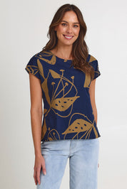 Model Madeline wearing size S of the Tilly Cotton Top in colour Navy (Blue), from the front, cropped image