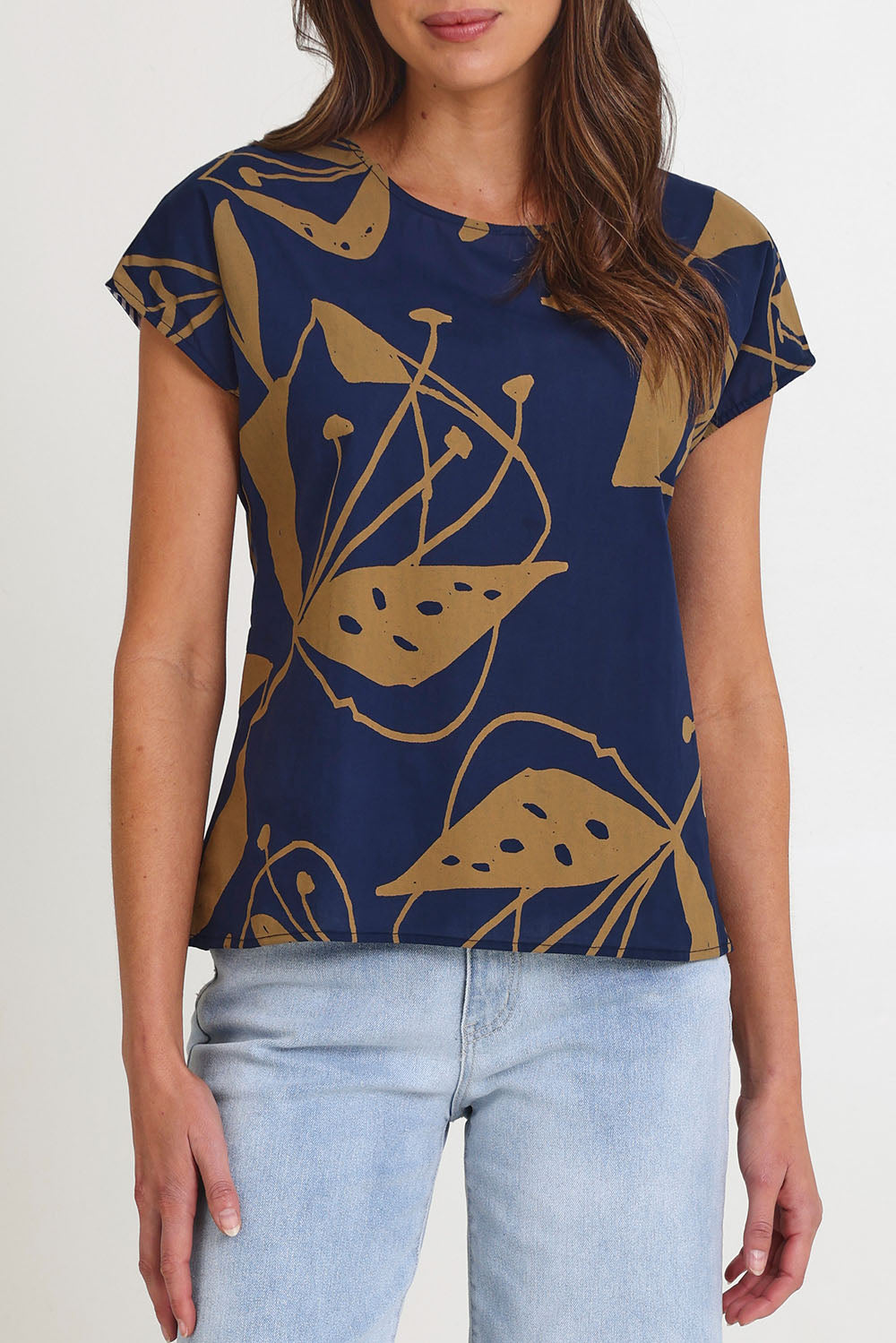 Model Madeline wearing size S of the Tilly Cotton Top in colour Navy (Blue), from the front, cropped image