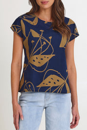 Model Madeline wearing size S of the Tilly Cotton Top in colour Navy (Blue), from the front, cropped image