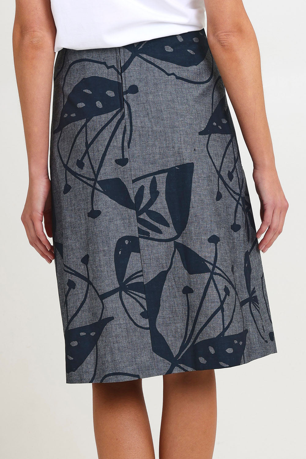 Model Madeline wearing size S of the Avril Long Cotton Skirt in colour Chambray (Grey), from the back