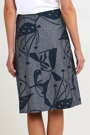 Model Madeline wearing size S of the Avril Long Cotton Skirt in colour Chambray (Grey), from the back