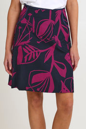 Model Madeline wearing size S of the Avril Cotton Skirt in colour Navy (Blue), from the front, cropped image