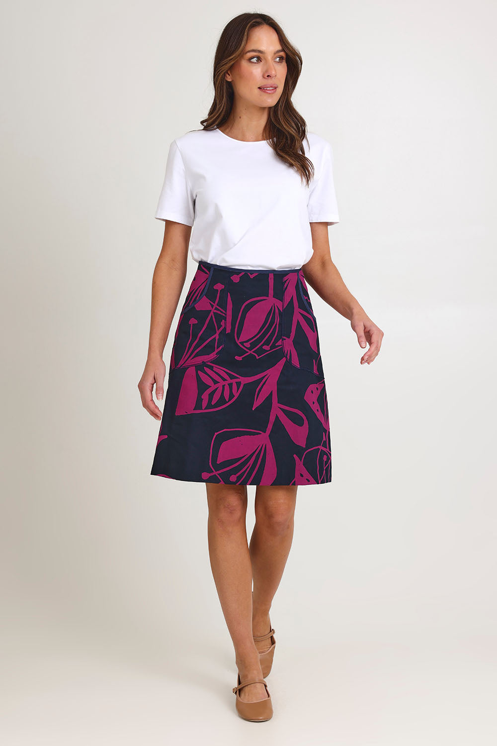 Model Madeline wearing size S of the Avril Cotton Skirt in colour Navy (Blue), from the front, showing the whole outfit