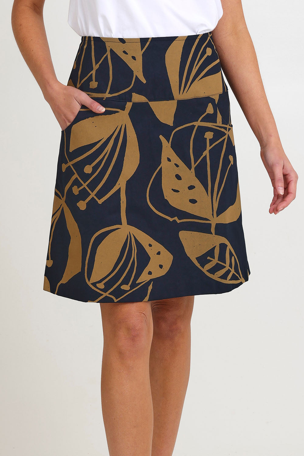 Model Madeline wearing size S of the Ivy Cotton Skirt in colour Navy (Blue), from the front, cropped image