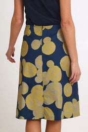 Model Madelinec wearing size 10 of the Heidi Long Skirt - Navy in colour Navy, from the back