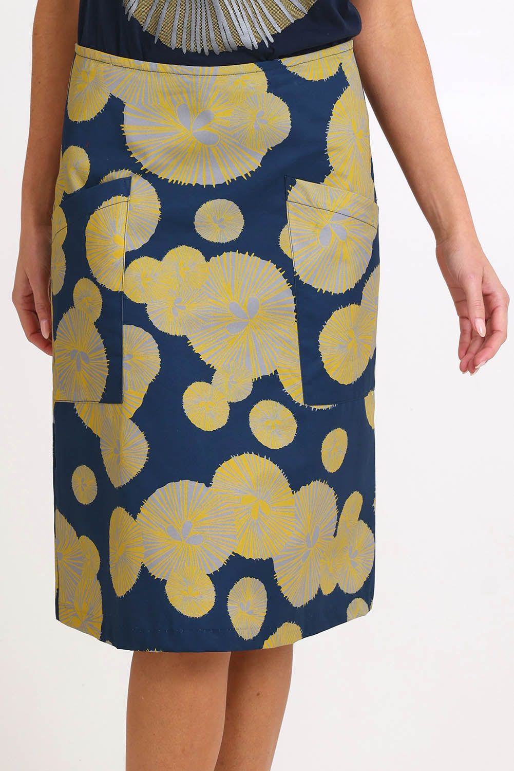 Model Madelinec wearing size 10 of the Heidi Long Skirt - Navy in colour Navy, in a cropped view