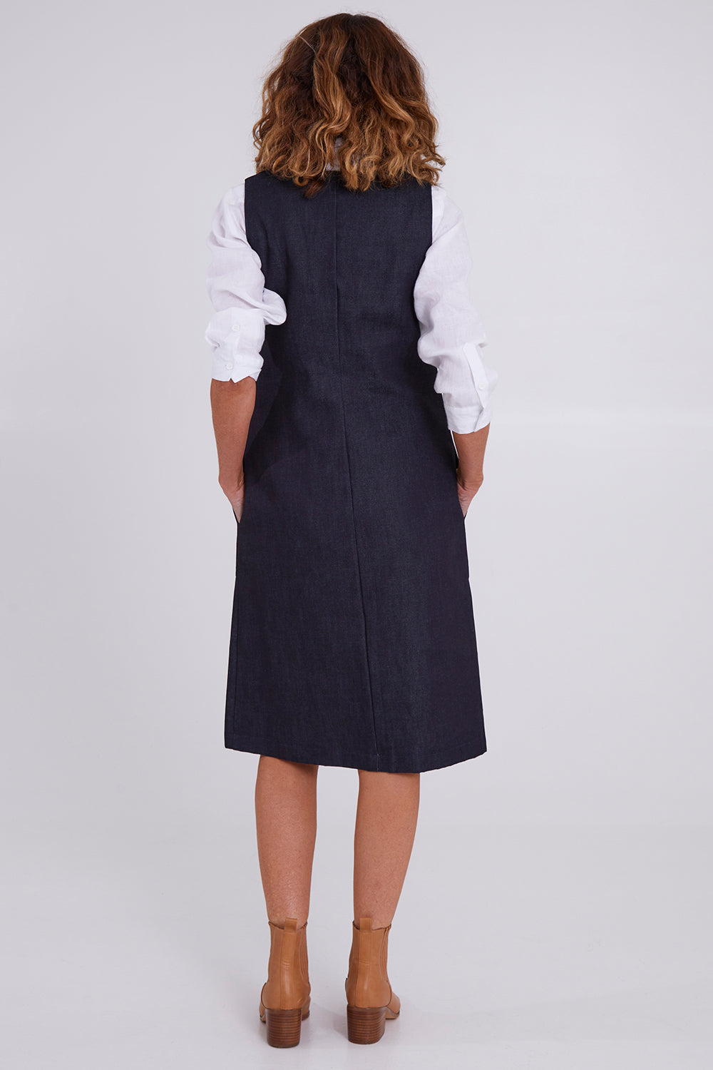 Model Emma wearing size S of the Susanne Denim Dress in colour Indigo (Blue), from the back