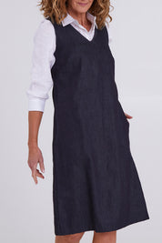 Model Emma wearing size S of the Susanne Denim Dress in colour Indigo (Blue), from the front, cropped image