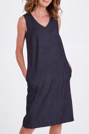 Model Emma wearing size S of the Susanne Denim Dress in colour Indigo (Blue), from the front, cropped image