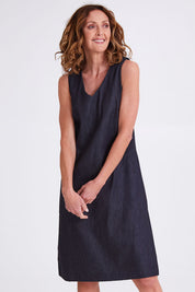 Model Emma wearing size S of the Susanne Denim Dress in colour Indigo (Blue), from the front, cropped image