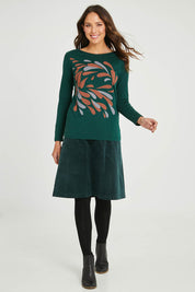 Model Madeline wearing size S of the Hanna Placement Tee in colour Forest (Green), from the front, showing the whole outfit