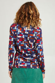 Model Emma wearing size S of the Abstract Boat Neck Tee in colour Blue (Blue), from the back