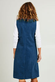 Model Emma wearing size S of the Corduroy Susie Dress in colour Teal (Blue), from the back