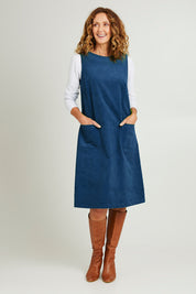 Model Emma wearing size S of the Corduroy Susie Dress in colour Teal (Blue), from the front, showing the whole outfit