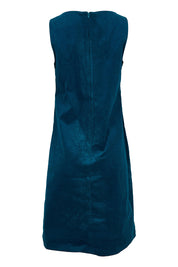 Product shot of the Corduroy Susie Dress in colour Teal (Blue), from the back
