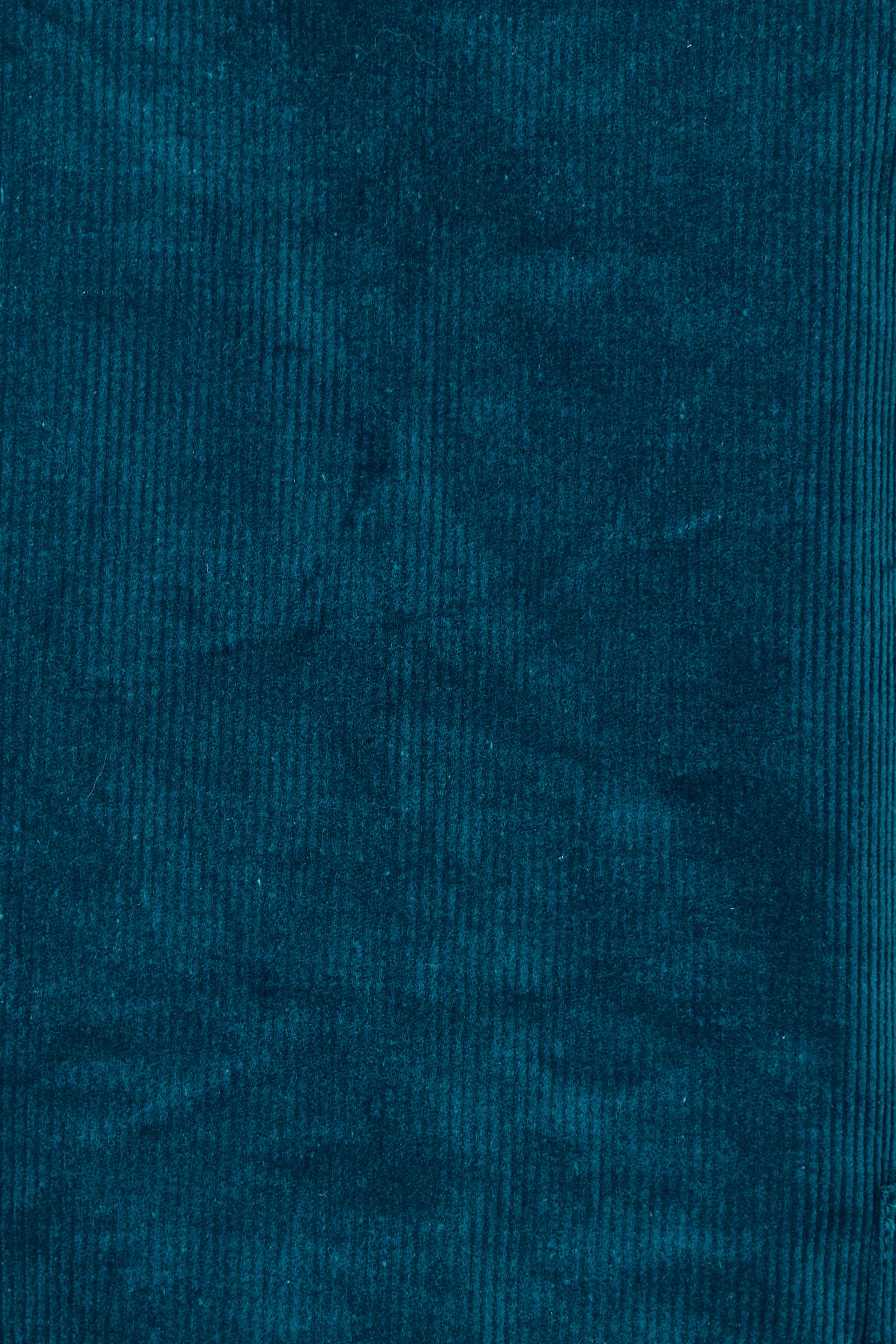 Product shot of the Corduroy Susie Dress in colour Teal (Blue), detail