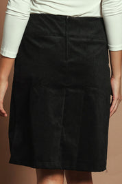 Model Madeline wearing size S of the Amy Cord Skirt in colour Black (Black), from the back