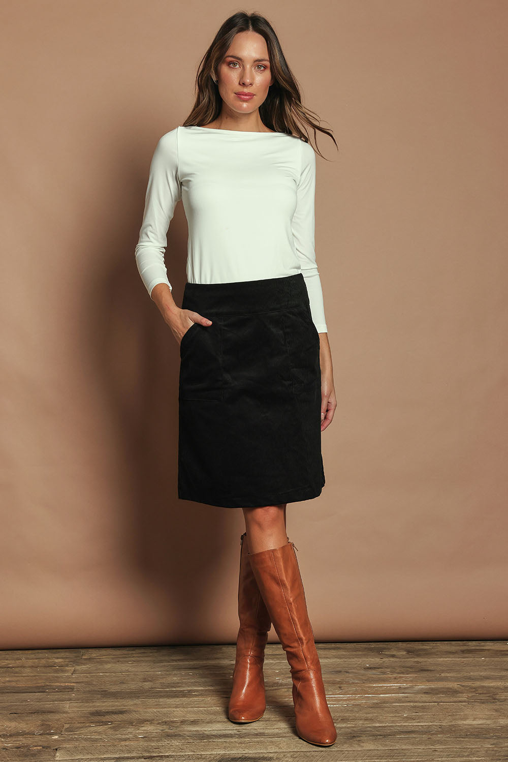 Model Madeline wearing size S of the Amy Cord Skirt in colour Black (Black), from the front, showing the whole outfit