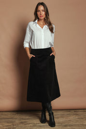 Model Madeline wearing size S of the Amy Cord Midi Skirt in colour Black (Black), from the front, showing the whole outfit