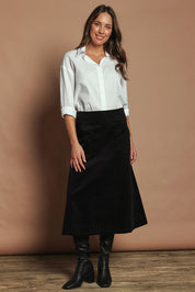Model Madeline wearing size S of the Amy Cord Midi Skirt in colour Black (Black), from the front, showing the whole outfit