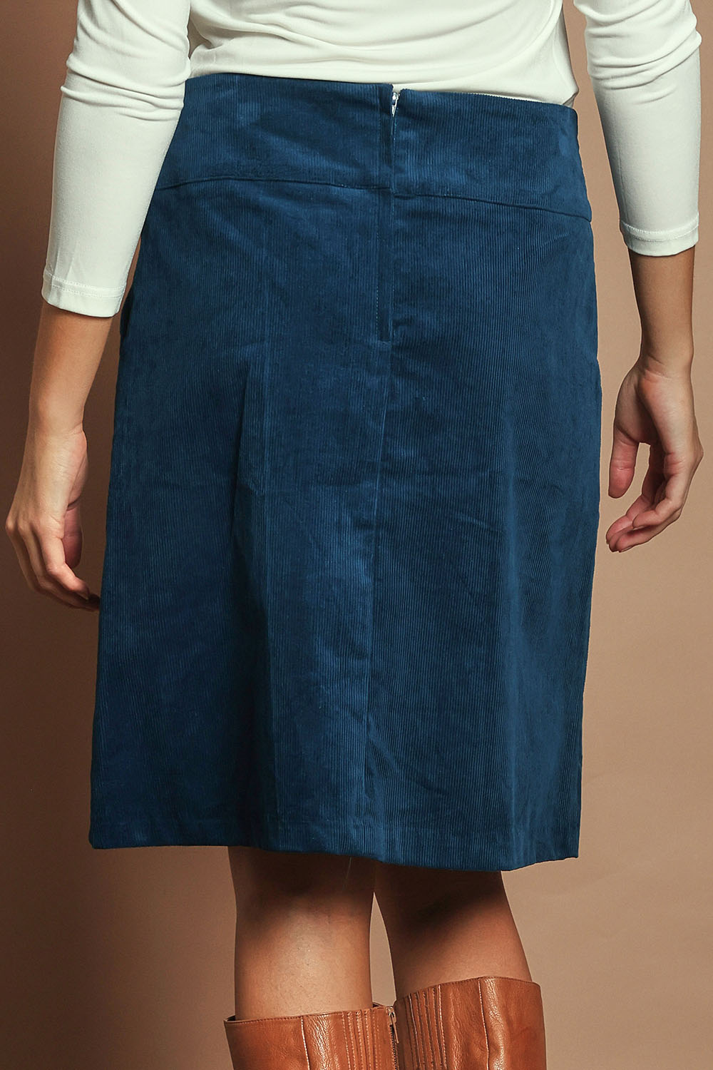 Model Madeline wearing size S of the Amy Cord Skirt in colour Teal (Blue), from the back