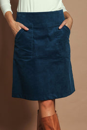 Model Madeline wearing size S of the Amy Cord Skirt in colour Teal (Blue), from the front, cropped image