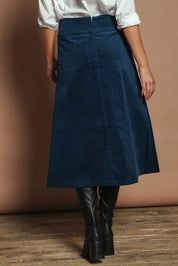 Model Madeline wearing size S of the Amy Cord Midi Skirt in colour Teal (Blue), from the back