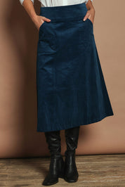 Model Madeline wearing size S of the Amy Cord Midi Skirt in colour Teal (Blue), from the front, cropped image