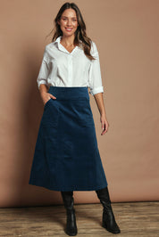Model Madeline wearing size S of the Amy Cord Midi Skirt in colour Teal (Blue), from the front, showing the whole outfit
