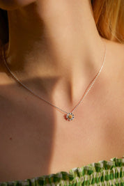 A model wearing the Wildflower Necklace in colour Silver (Metallics), from the front, cropped image