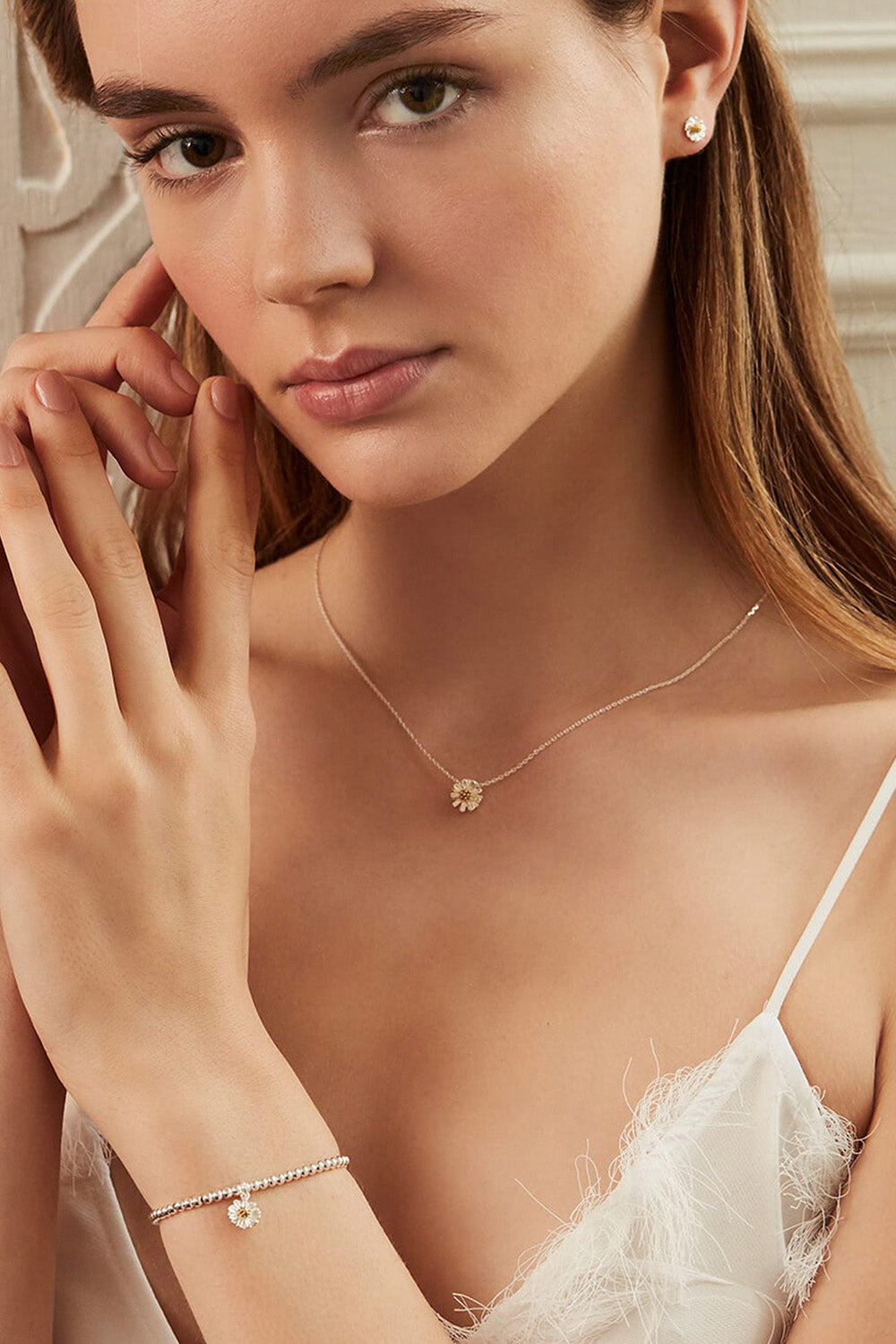 A model wearing the Sienna Wildflower Bracelet in colour Silver (Metallics), from the front, cropped image