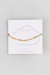 Model Genericm wearing size sample of the Double Chain Rainbow Beaded Bracelet – Goldmulti in colour Goldmulti, from the front