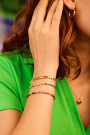 A model wearing the Coco Bead & Tourmaline Bracelet Set in colour Goldmulti (Metallics), from the front, showing the whole outfit