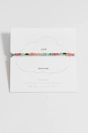 A model wearing the Green & Pink Mixed Mini Bead Bracelet in colour Greenpink, from the front, showing the whole outfit