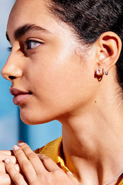 A model wearing the Pave Set Hoop Earrings in colour Silver (Metallics), from the front, showing the whole outfit
