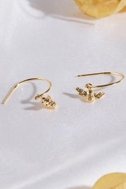 A model wearing the Bee Hoop Earrings in colour Gold (Metallics), from the front, showing the whole outfit