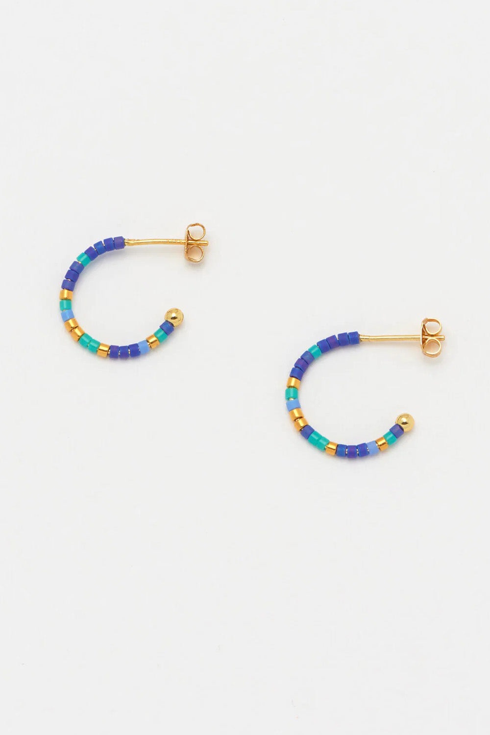 Product shot of the Night Sky Beaded Hoop Earring in colour Bluegold (Blue), detail