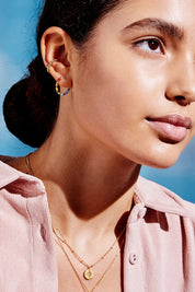 A model wearing the Rainbow Beaded Hoop Earrings in colour Goldrainbo (Metallics), from the front, cropped image