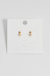 A model wearing the White Enamel Double Flower Studs in colour Whitegold (White), from the front, showing the whole outfit