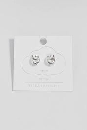 Product shot of the Hammered Huggie Hoops – Silver in colour Silver, from the front