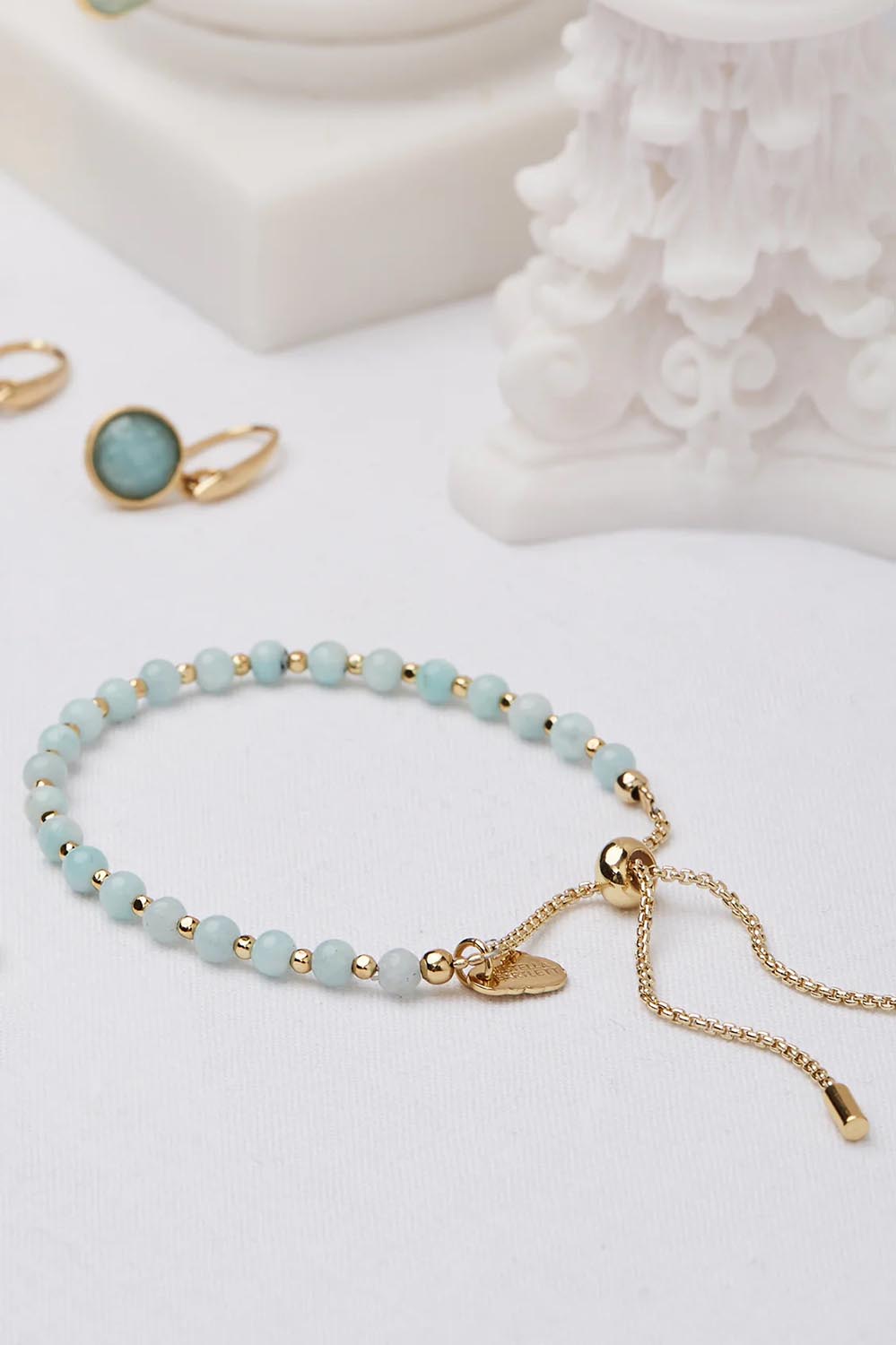 A model wearing the Amelia Amazonite Bracelet in colour Amazonite (Green), from the front, showing the whole outfit